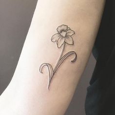 a single flower tattoo on the arm