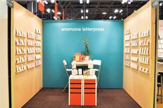 the interior of an electronics store with many books on shelves and a table in front of it