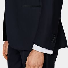 Tailored navy three-piece tuxedo with a silk-covered peak lapel, and silk-trimmed jetted pockets. A smart half-canvas build with a one-button closure lends a sharp look. Black-tie Tuxedo With Notch Lapel, Formal Tuxedo With Concealed Placket, Navy Tuxedo Style Three-piece Suit For Formal Occasions, Navy Tuxedo For Formal Occasions, Navy Three-piece Tuxedo For Formal Occasions, Luxury Tuxedo With Concealed Placket For Black-tie Events, Elegant Tailored Navy Tuxedo, Luxury Tuxedo For Black-tie Events With Concealed Placket, Elegant Navy Tuxedo For Semi-formal Occasions