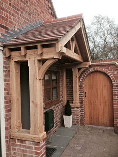 a brick house with an arched wooden door