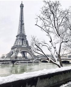 the eiffel tower in winter with snow on the ground