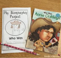 two children's books are sitting on a wooden table, one has a cowboy hat and the other is a dog