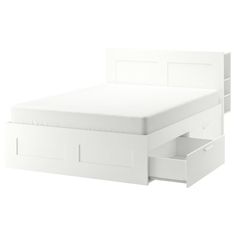 a white bed with drawers underneath it on a white background and the bottom drawer is open