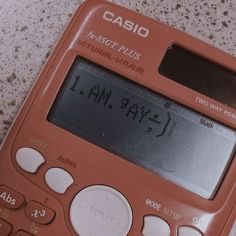 an orange calculator sitting on top of a table