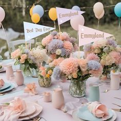 the table is set with pink and blue flowers in vases, plates and napkins