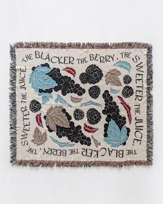 an embroidered wall hanging with flowers and words on it, in blacker the berry