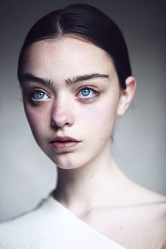 a woman's face is shown with blue eyes and dark hair, as well as an image of her head