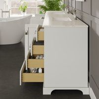 a white sink sitting next to a bath tub in a bathroom