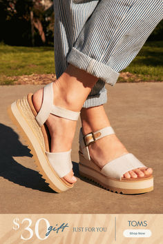 Ultra-lightweight midsole, stylish rope wrap, and a secure adjustable ankle strap to take you through the day with ease.
Height with No Compromise:  
Get that perfect mid-height boost with our natural platform wedge—where elegance meets comfort.
We’re committed to fashion that feels good and does good. Step into sustainable style with every pair.
Start Your Shoe Love Story with Diana—a sandal that understands it’s not just about where you go, it's about how you get there. Black Toms, Rope Wrapped, Travel Outfits, Womens Toms, Platform Wedge, Wedge Sandal, Black Canvas, Platform Wedges, Travel Outfit