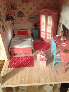 a doll house with a bed, desk and chair in the room that is made to look like a bedroom