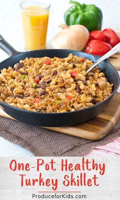 one pot healthy turkey skillet recipe with tomatoes, carrots and onions in the background