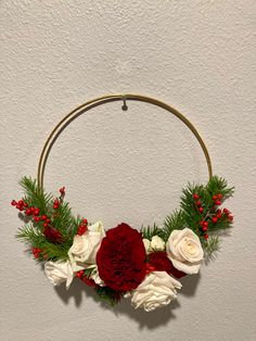 a christmas wreath with red and white flowers