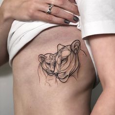 a woman's stomach with a tattoo of a tiger on it