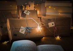 presents wrapped in brown paper and tied with twine on top of an open book