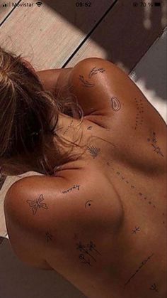 the back of a woman's body with writing on it