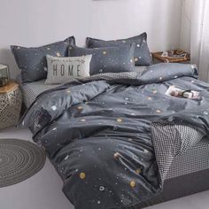 a bed with space themed sheets and pillows