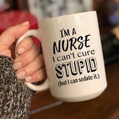 White ceramic mug with the funny nurse sayings: I'm a nurse. I can't cure STUPID (but I can sedate it) This coffee mug makes a funny gift for nurses, nursing students, or a funny nurse graduation gift! * ****At checkout, add to the NOTES BOX on the CART PAGE: 1. NAME to put on the back if you chose that option at purchase.If you DO NOT choose to add a name the funny nurse quote design will be on both sides of the mug. Material: Ceramic, Glossy Finish -Please note that the actual print colors may Nurse Mugs Coffee Cups, Nurse Sayings For Cups, Sayings To Put On Cups, Nurse Cup Ideas, Nurse Sayings Quotes, Nurse Life Quotes, Nurse Cups, Taylor Graduation, Nurses Quotes