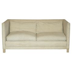 a white couch sitting on top of a wooden frame