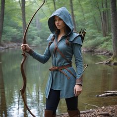 a woman dressed in medieval clothing holding a bow and arrow while standing next to a body of water