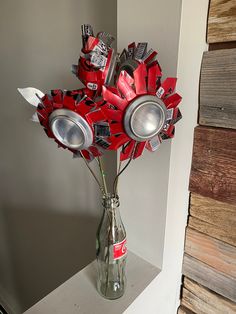 a vase filled with red flowers sitting on top of a table