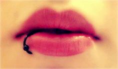 a woman's lips are shown with the lip ring