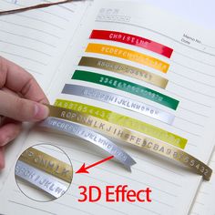 a hand holding a bookmark with the words 3d effect in different colors and sizes