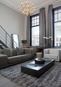 a living room filled with furniture and a chandelier