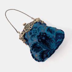 Introducing our captivating collection of Chatelaine purses, inspired by the elegance of the Victorian era.Available in three sizes—Large, Medium, and Small—these purses offer versatility and style. The Large and Medium sizes can be used as both a clutch and a crossbody purse, as we provide two chains for each size: 50" and 13" in length. This allows you to effortlessly switch between crossbody and clutch styles.Let's focus on the Chatelaine Large Crossbody Purse:With a frame width of 6.25" and a height of 8", this purse comfortably holds larger items like the iPhone 14 Pro Max and a passport. It features a small slip pocket for cards or small essentials, and the 1.5" bottom depth provides ample space for your necessities.The Large Crossbody Purse includes two chains, each with brass hooks Elegant Blue Pouch Coin Purse, Elegant Blue Coin Purse Pouch, Victorian Pouch Bags As Gifts, Vintage Blue Bag For Wedding, Victorian Style Pouch Bag For Gift, Victorian Pouch Bag For Gift, Victorian Style Pouch Bag As Gift, Vintage Blue Bags For Wedding, Victorian Style Formal Pouch Bag