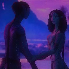 two people standing next to each other in front of a purple sky