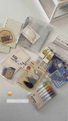 an assortment of stationary items displayed on a table