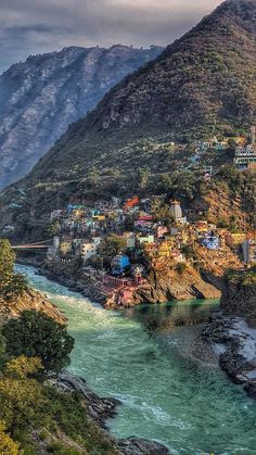 a river running through a lush green hillside