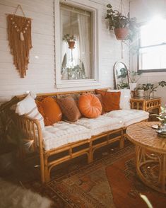 a living room filled with furniture and plants