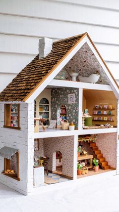 a doll house with furniture and accessories inside