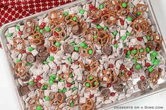 a tray filled with candy and pretzels on top of a table