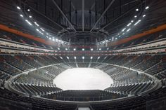 an empty auditorium with rows of seats and lights on the ceiling is seen in this image