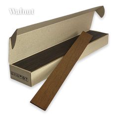 an open cardboard box with a wooden handle