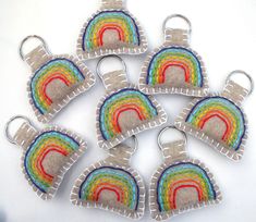 six rainbow shaped key chains on white background