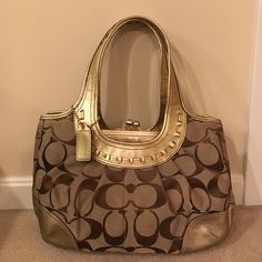 Never Been Used! Beautiful Purse That Compliments Any Outfit. Elegant Shopping Bag With Brass Hardware, Elegant Gold Shoulder Bag With Branded Hardware, Elegant Tote Bag With Brass Hardware, Luxury Coach Bag With Brass Hardware, Chic Gold Coach Shoulder Bag, Coach Gold Top Handle Shoulder Bag, Coach Bags With Brass Hardware, Coach Gold Shoulder Bag With Handle Drop, Gold Coach Top Handle Shoulder Bag