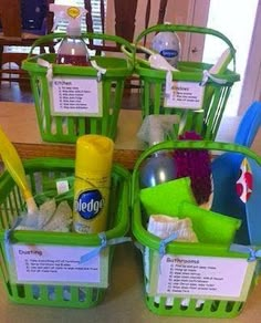 three green plastic baskets filled with cleaning products on top of a wooden table next to a mirror