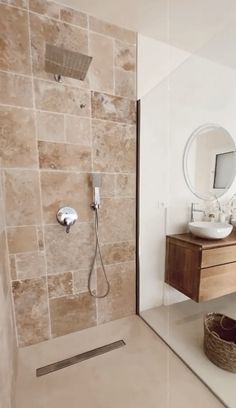 a bathroom with a sink, mirror and shower head on the wall next to it