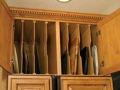 an open cabinet filled with knives and cutting boards