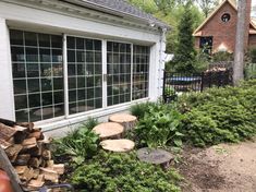 there is a pile of wood in front of the house