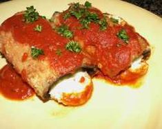 a white plate topped with meat covered in sauce