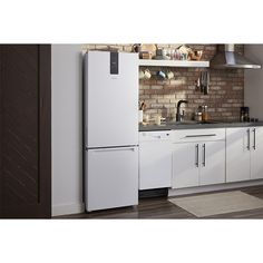 a white refrigerator freezer sitting inside of a kitchen