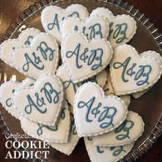 some cookies that are shaped like hearts on a plate with the words abc and h