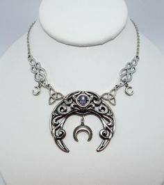 This is a new handmade necklace. It is made with antiqued silver plated celtic knots and crescent moons, accented with a high quality LIGHT VIOLET PURPLE glass rhinestones that sparkles like crystal. Decorated portion is 5 1/4" wide and 1 7/8" tall in the center. Necklace is adjustable 15-18" with a lobster clasp and chain extender. If you would like a different length, please send us a message.Matching headpiece is listed in our store in a variety of stone colors. If you don't see items with a Purple Crescent Moon, Celtic Knots, Light Sapphire, Peridot Green, Choker Pendant, Chain Extenders, Moon Goddess, Amethyst Purple, Necklace Choker