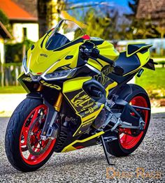 a yellow and red motorcycle parked on the street