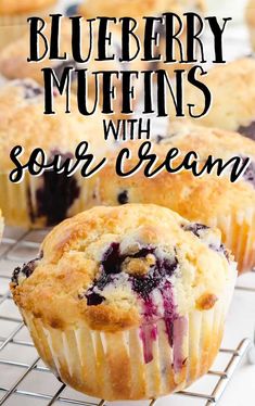 blueberry muffins with sour cream on a cooling rack and text overlay reads, blueberry muffins with sour cream