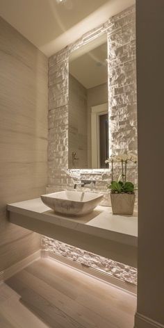 a bathroom sink sitting under a large mirror