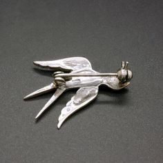 A charming vintage 835 silver pin, decorated with sparkling marcasite crystals. This dainty mid century 1950's brooch is featuring a small bird, a swallow. Would add a nice accent to any outfit. The brooch will be shipped in a gift box. The brooch measures 1 1/5 Inches wide by 9/10 inches tall (3.0 cm x 2.3 cm) Weight: 2.7 grams Hallmarked for 835 silver Rollover clasp Excellent vintage condition, with lovely patina. The standard shipping for this item is with tracking. If you prefer a faster sh Retro Silver Brooch Pin, Silver Retro Brooch Pin, Mid-century Silver Brooch For Collectors, Mid-century Silver Brooches For Collectors, Retro Silver Brooches For Anniversary, Silver Retro Brooches For Anniversary, Vintage Silver Lapel Pin For Anniversary, Vintage Silver Pins For Anniversary, Vintage Silver Anniversary Lapel Pin